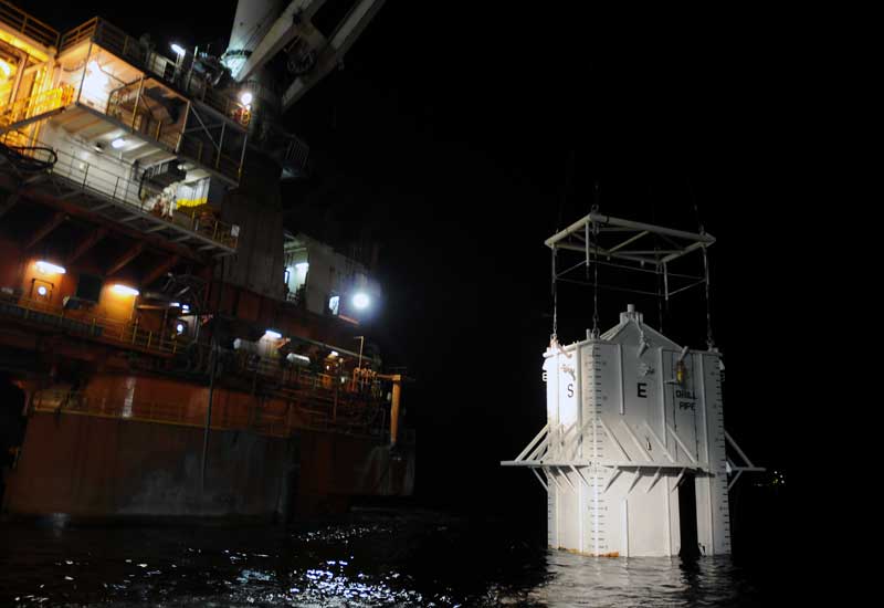 BP's radical containment dome lowered into Gulf